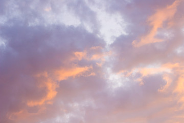 Fototapeta na wymiar Pink clouds in the blue sky at sunset