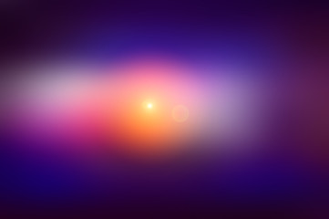 Abstract blurred background and light flash of light. Dark blue and purple, orange spot.