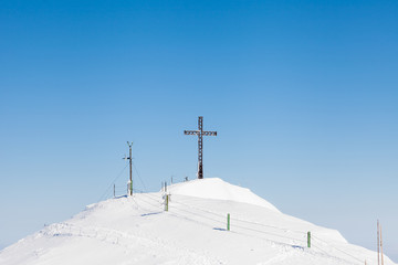 Untersberg Summit. The view across the summit of Untersberg mountain in Austria looking towards a cross. The mountain straddles the border between Germany and Austria.