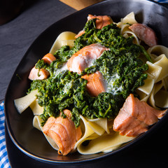 pappardelle pasta with creamed spinach and fried salmon