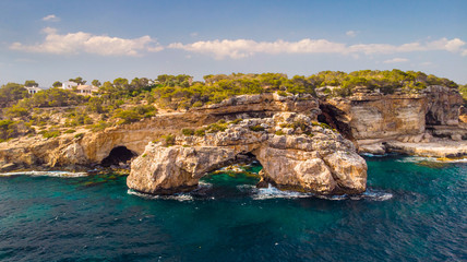 Fototapeta na wymiar Rocky Arch in the sea, view from sea. Popular tourist destinations. Amazing natural wonder. Mirador Es Pontas, Samtanyi, Mallorca, Balearic Islands