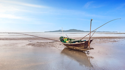 fishing boat docking on the sand bars in morning sunrise