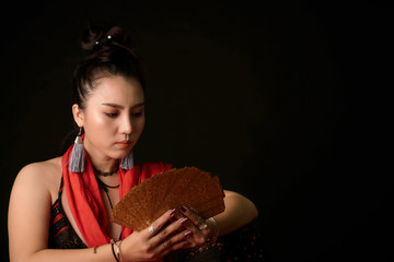 Tarot Cards fortune teller reading holding and predicting future and the passes in the dark room