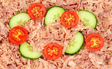 Slow cooked shredded pulled pork with cucumber slices and tomatoes background