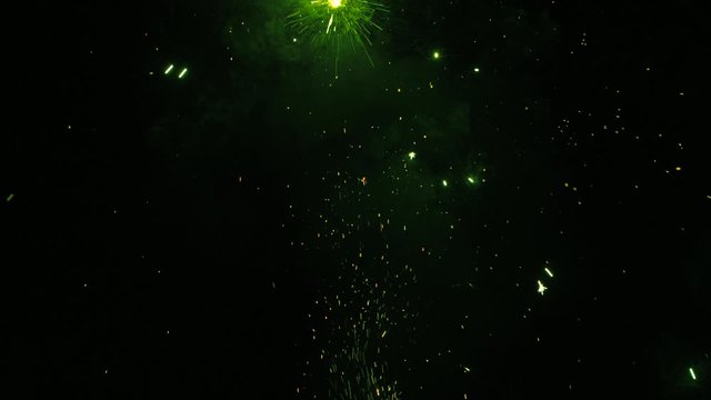 Sparkling green fireworks on black background during celebrating holiday of saint patrick. Perfect for creating video effects, digital compositing.