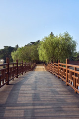 A view of wooden bridge and a dirt path at the Uirimji Reservoir in Jechun, South Korea.