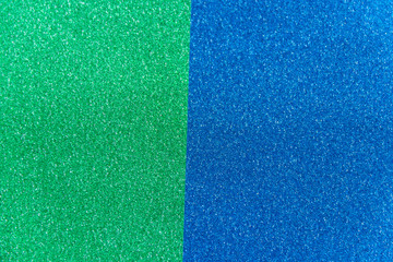 Fototapeta premium Green and blue sparkling background from small sequins, closeup. Brilliant shiny backdrop from textile.