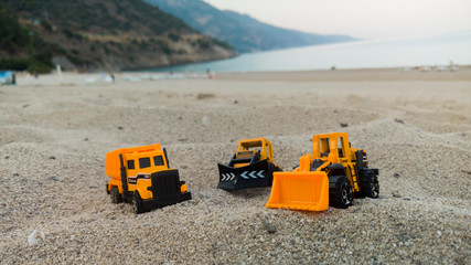 Construction vehicles toys at beach