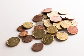 European Euro coins spilled on white surface