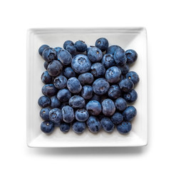 a lot of ripe blueberries on a square white plate