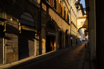 Fototapeta na wymiar Narrow street in Florence city, Italy in the sunset