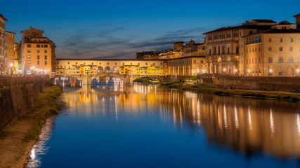 Fototapeta na wymiar Ponte Vecchio bridge over Arno river in Florence city, Italy in the sunset
