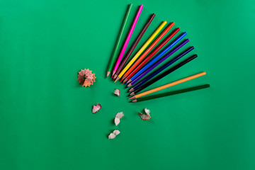 School tools color pencils,studies accessories on a paper dark green background. Flat lay