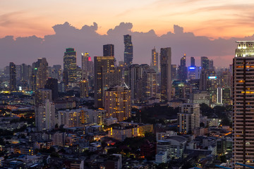 Cityscape with sunset over the building and Golden sky at Bangkok ,Thailand. Landscape of the tall building in capital with twilight.