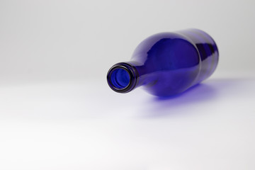 Empty blue glass bottle on the table.
