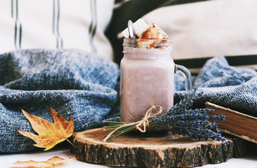 mug of hot cocoa with waffles on the bed. autumn mood