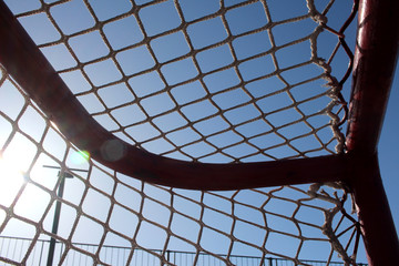 football net stretched on a sports frame hockey goal against the sky