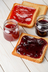 Spreading jam on toasted bread