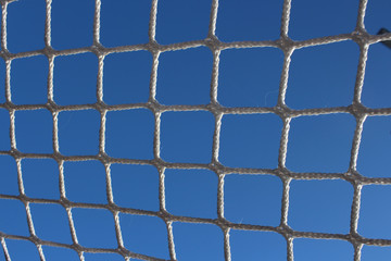 Fototapeta premium football net stretched on a sports frame hockey goal against the sky