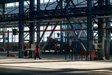 Naklejka premium A builder in a work robe is engaged in the installation and construction of an industrial building at the Zvezda shipyard