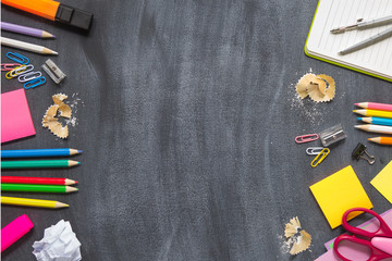 School supplies on a blackboard background. Concept back to school. With copy spice. Top view.