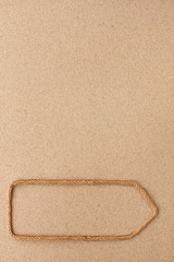 Pointer made of rope on the sand. With space for design, text place.