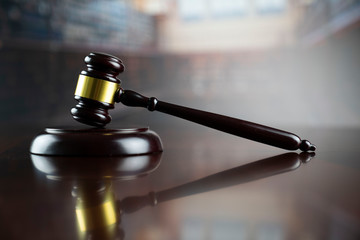 Law, auction and business concept.  Gavel in the lawyer library.