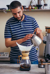Cup of Dripping fresh hot coffee on the paper filter