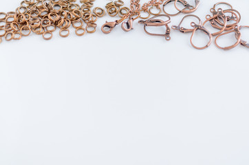 Assorted jewelry making supplies background with space for text.