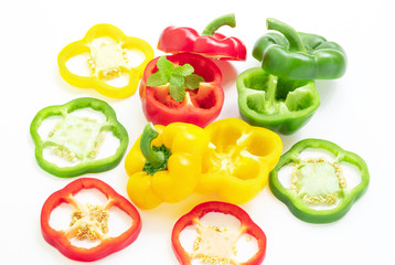 Freshness of thinly sliced sweet peppers overlaid with mint, isolated on white background.