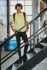 Young man on the stairs of old building