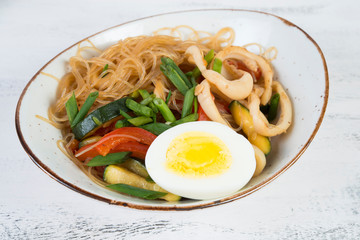 Traditional Asian stir fry with noodles, seafood and vegetables.