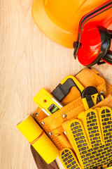 Protective equipment and tools in a bag for a builder.