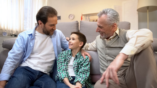 Grandpa and dad sharing experience with preteen boy, family bounds, togetherness