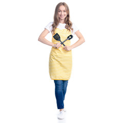 Woman in yellow apron with kitchen utensils tools in hand on white background isolation