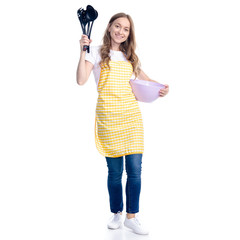 Woman in yellow apron with kitchen bowl and tools utensils in hand on white background isolation