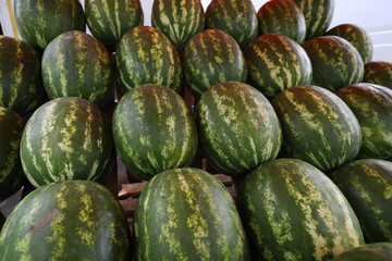 The watermelons laid out on a market stall