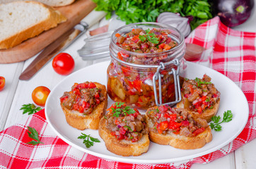 Crispy toasts with eggplant caviar on a white plate