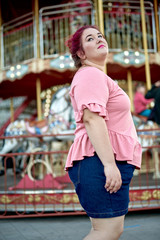 Fat and young woman walking in city