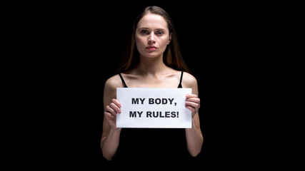 Woman showing my body my rules sign, accepting individual imperfections, freedom