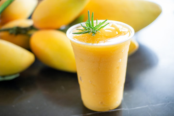 Fresh Mango smoothie in plastic glass.