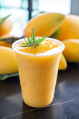 Side view of Fresh Sweet Mango juice in plastic glass.Summer Drink in Thailand.