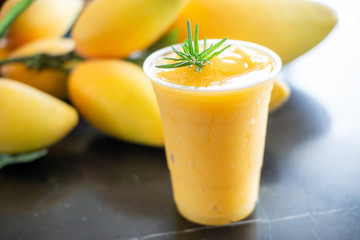 Fresh Mango smoothie in plastic glass.