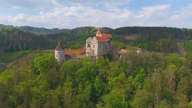 Aerial view of Moravian castle Pernstejn, standing on a hill above deep forests of the Bohemian-Moravian Highlands, Czech Republic, Europe
