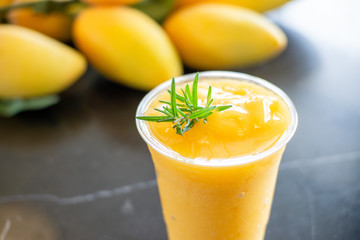 fresh mango juice  with plastic glass.