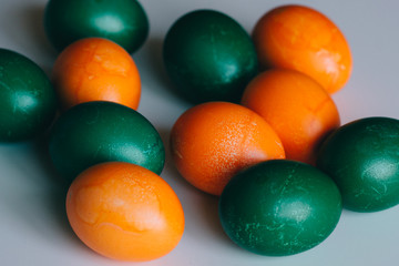 Small multi-colored Easter eggs on the kulich, festively decorated with colorful painted eggs paint, background