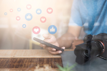 Close up hand holding smart phone with Social media concept.