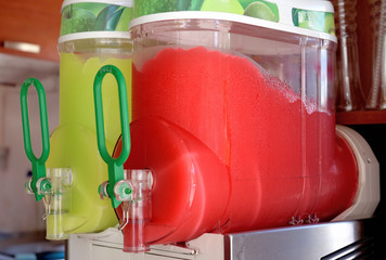 Multicolored iced juice with fresh watermelon and lime.