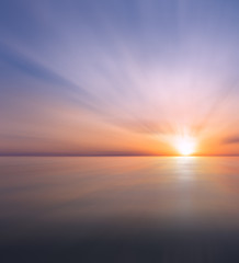 Abstract Sunset and sea with small waves.