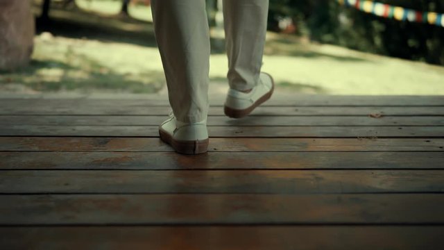 Man Walking In Beautiful Place.Stylish Businessman Walking In Buddhist Tample.Man Wearing Elegant Suit And Shoes.Man Foots Moving In Wooden Floor.